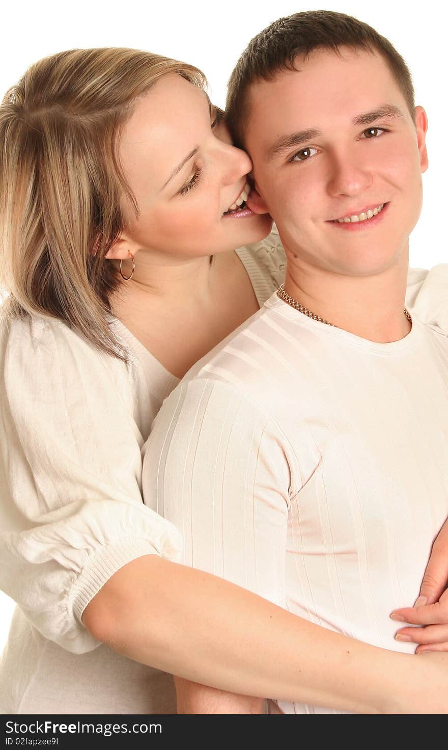 Beautiful young couple kissing isolated over white background. Beautiful young couple kissing isolated over white background