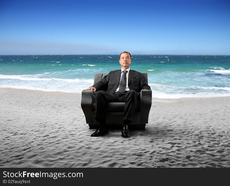 Japanese businessman sitting on an armchair at the seaside. Japanese businessman sitting on an armchair at the seaside