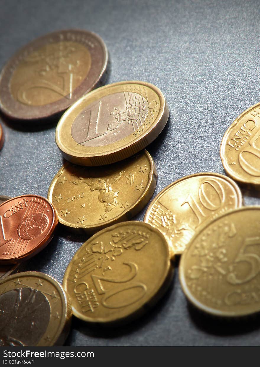 Lots of shiny euro coins on a blue background