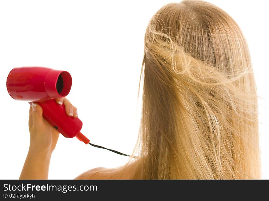 Blonde caucasian woman drying hair with red hairdryer