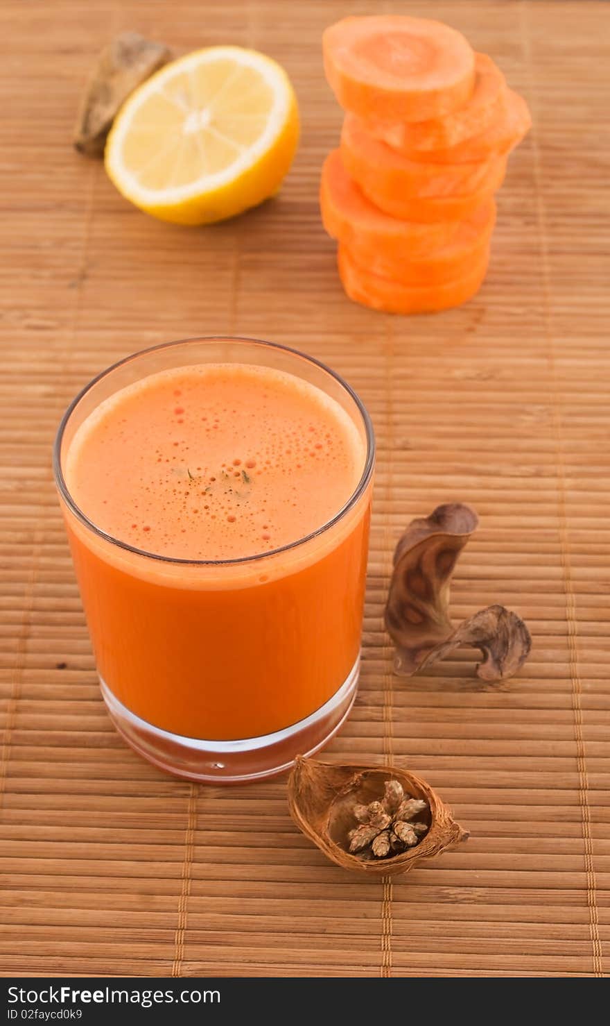 Fresh carrot juice and fruit with dried herbs