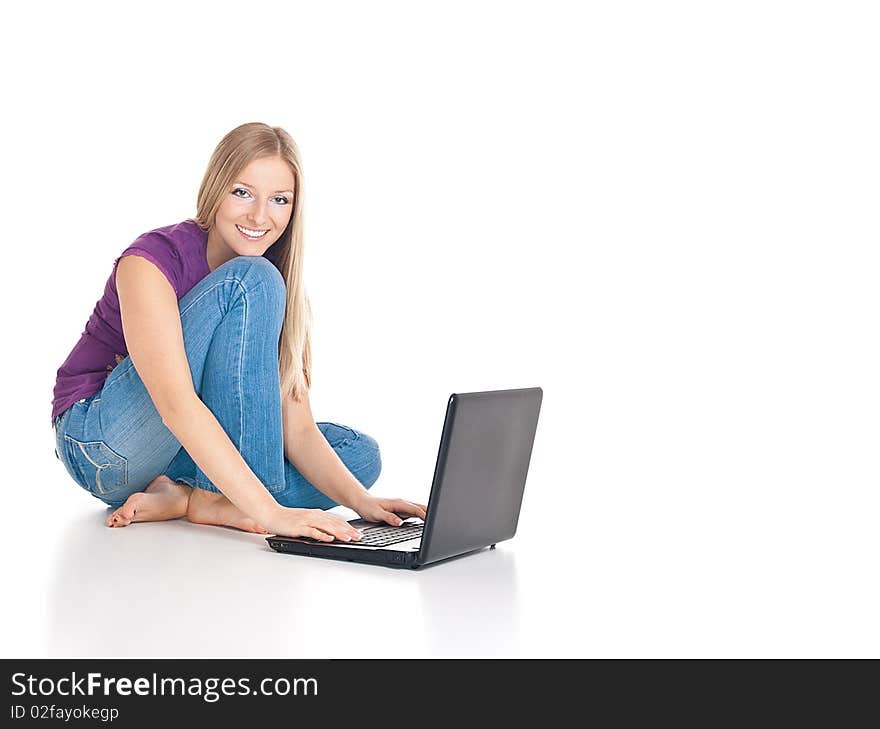 Smiling caucasian woman sitting on the floor with laptop computer. Smiling caucasian woman sitting on the floor with laptop computer