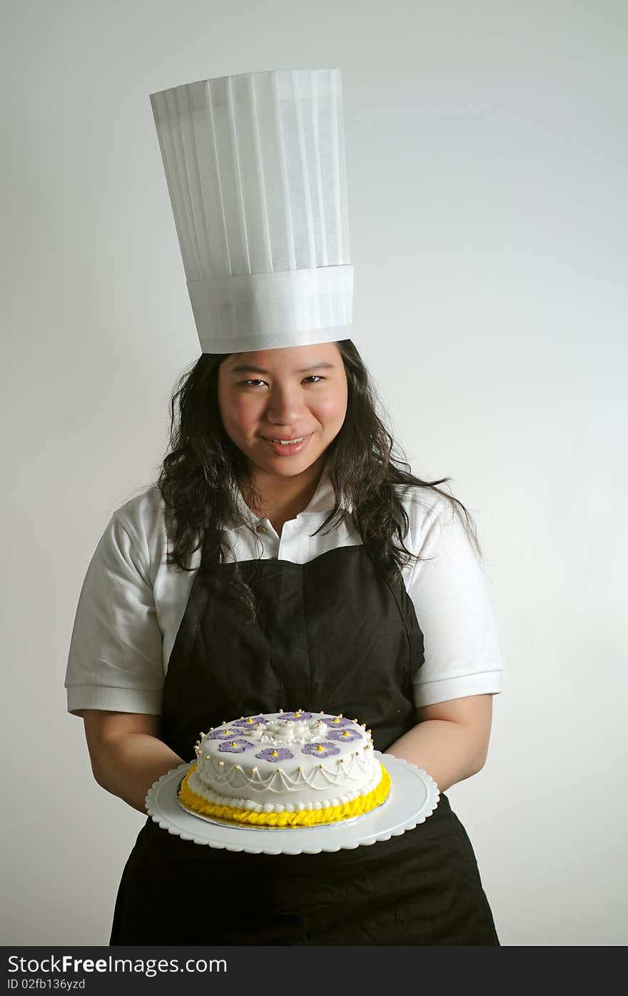 Baker presenting a (birthday cake) to the viewer. Useful for parties and celebrations. Baker presenting a (birthday cake) to the viewer. Useful for parties and celebrations.