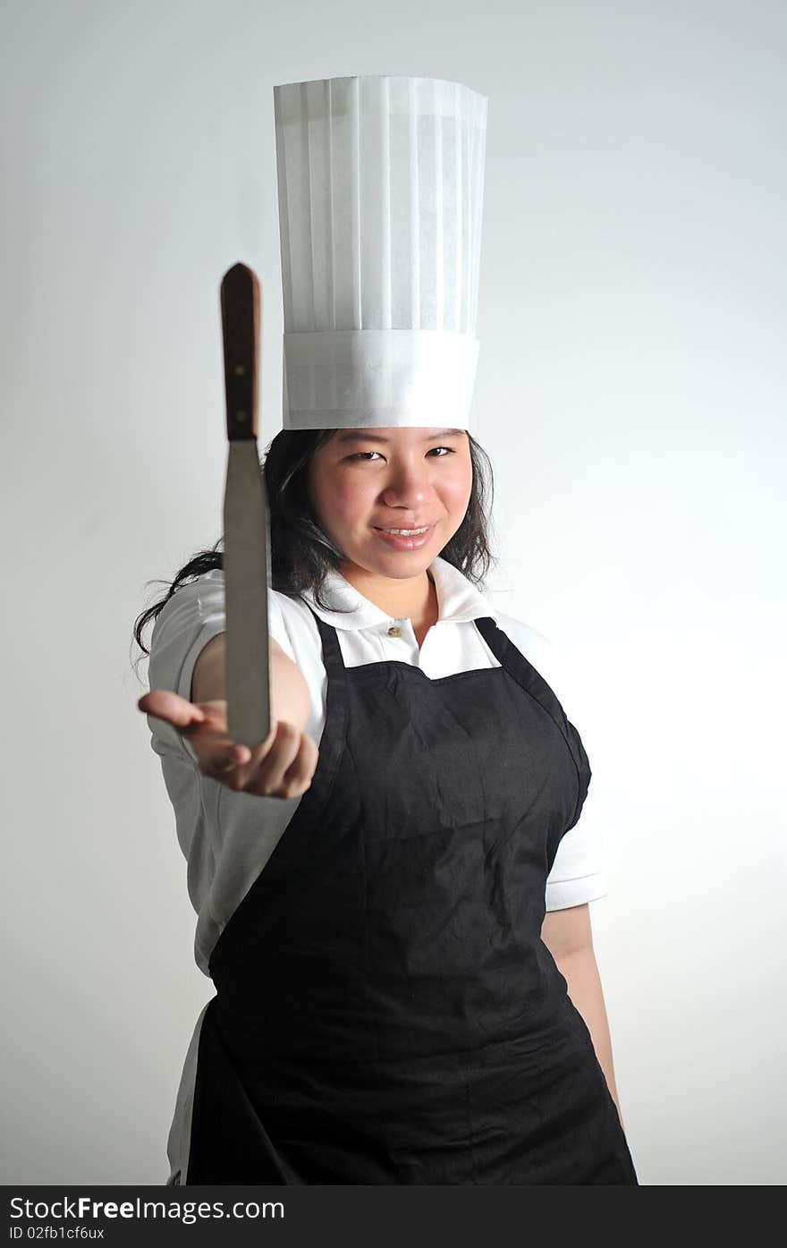 Chef delicately balancing her knife. Chef delicately balancing her knife