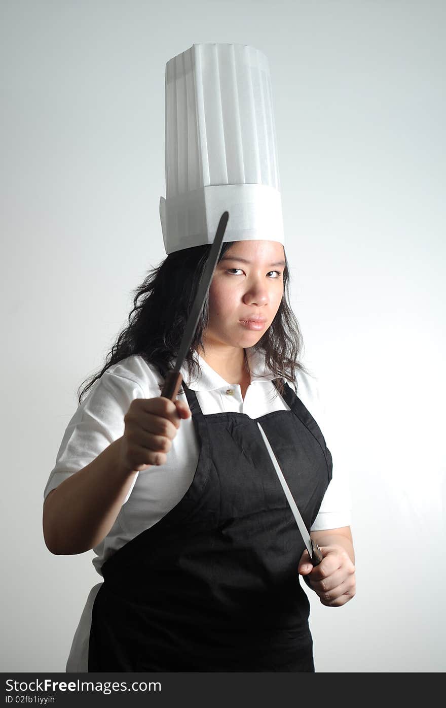 Asian Chef preparing to fight with knifes