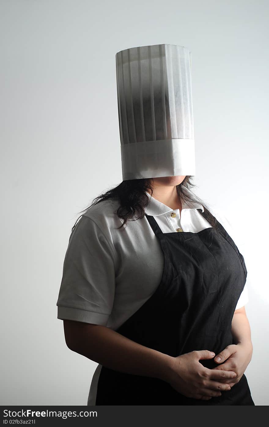 Chef wearing her hat over her head to deal with her cooking frustrations. Chef wearing her hat over her head to deal with her cooking frustrations