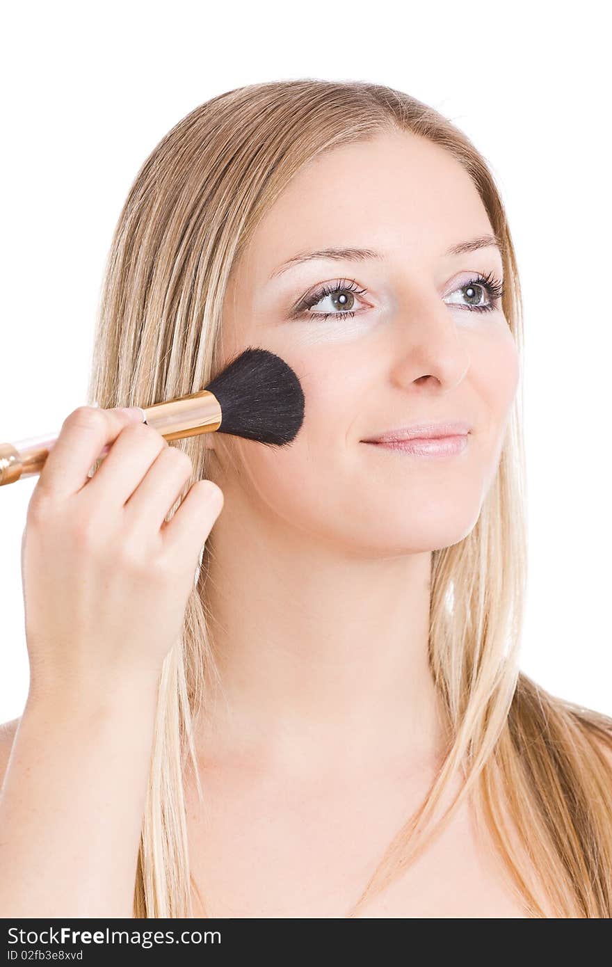 Woman makeup her face with brush