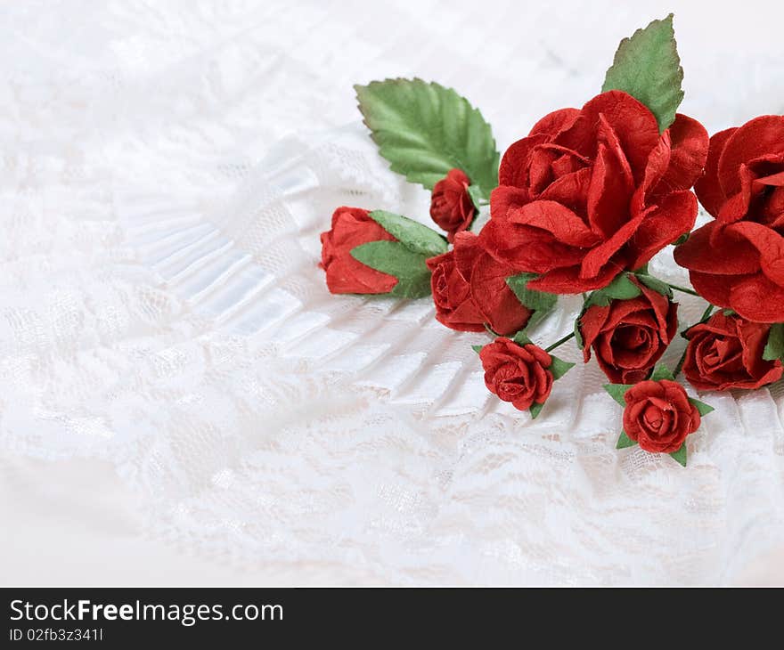 Closeup shot of red paper flowers on white background