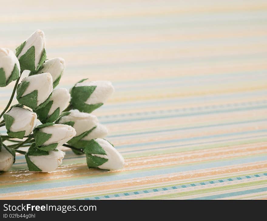 Closeup shot of white paper flowers on light background