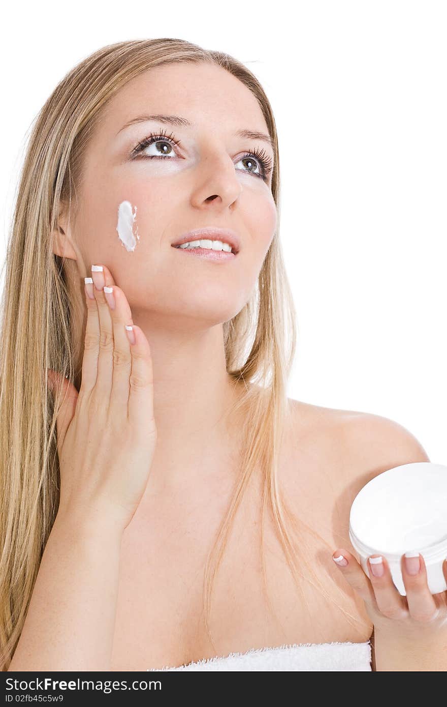 Caucasian blonde Woman creaming face on isolated background