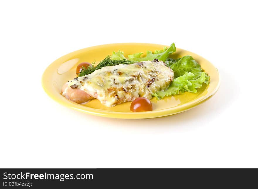Prepared fish with salad on yellow plate