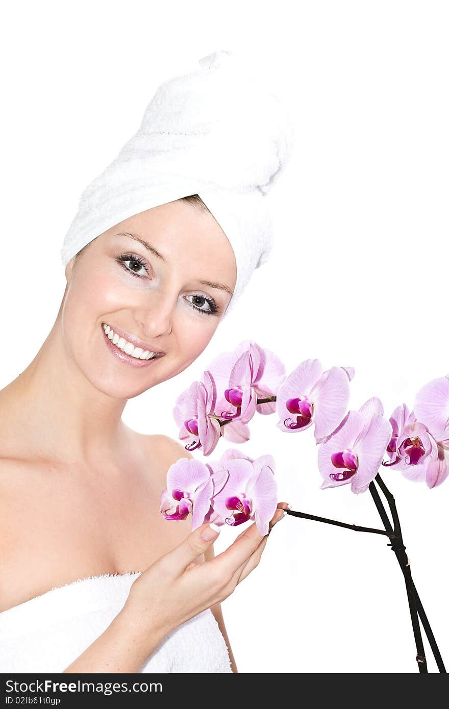 Caucasian woman with towel on head and violet orchids flowers. Caucasian woman with towel on head and violet orchids flowers