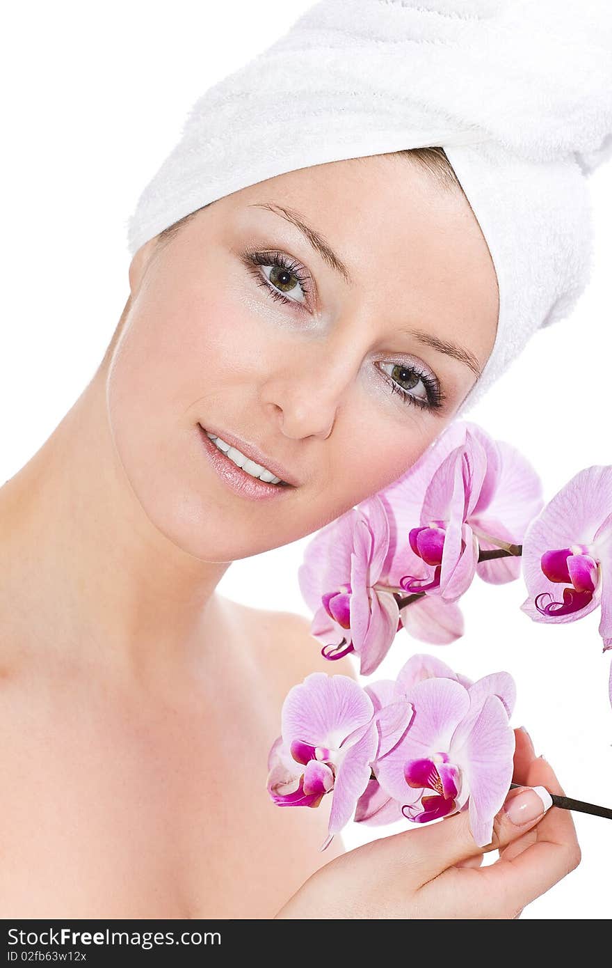 Caucasian woman with towel on head and violet orchids flowers. Caucasian woman with towel on head and violet orchids flowers