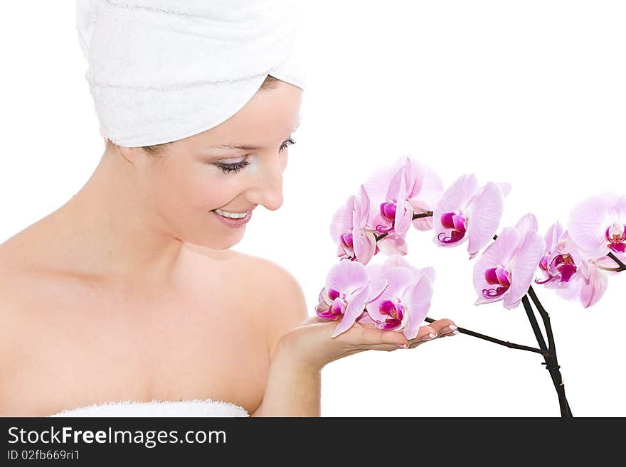 Caucasian woman with towel on head and violet orchids flowers. Caucasian woman with towel on head and violet orchids flowers