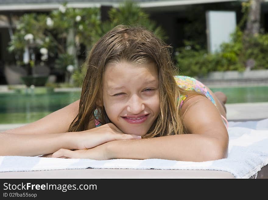 Girl portrait relaxing close to swimming pool