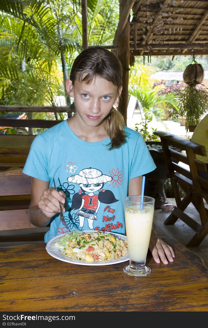 Young girl eating in restaurant