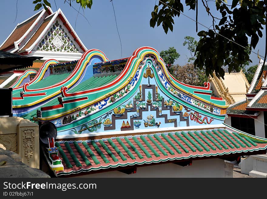 Curved, colouful roof with ornate designs of the Chinese temple on the lower level by the East Vihara at Phra Pathom Chedi in Nakhon Pathom, Thailand. Curved, colouful roof with ornate designs of the Chinese temple on the lower level by the East Vihara at Phra Pathom Chedi in Nakhon Pathom, Thailand.