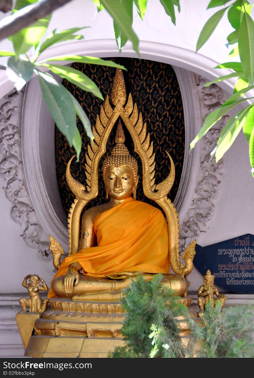 A serene, gilded Buddha sits in an alcove on the upper terrace circular cloister gallery at the Phra Pathom Chedi temple in Nakhon Pathom, Thailand. A serene, gilded Buddha sits in an alcove on the upper terrace circular cloister gallery at the Phra Pathom Chedi temple in Nakhon Pathom, Thailand.