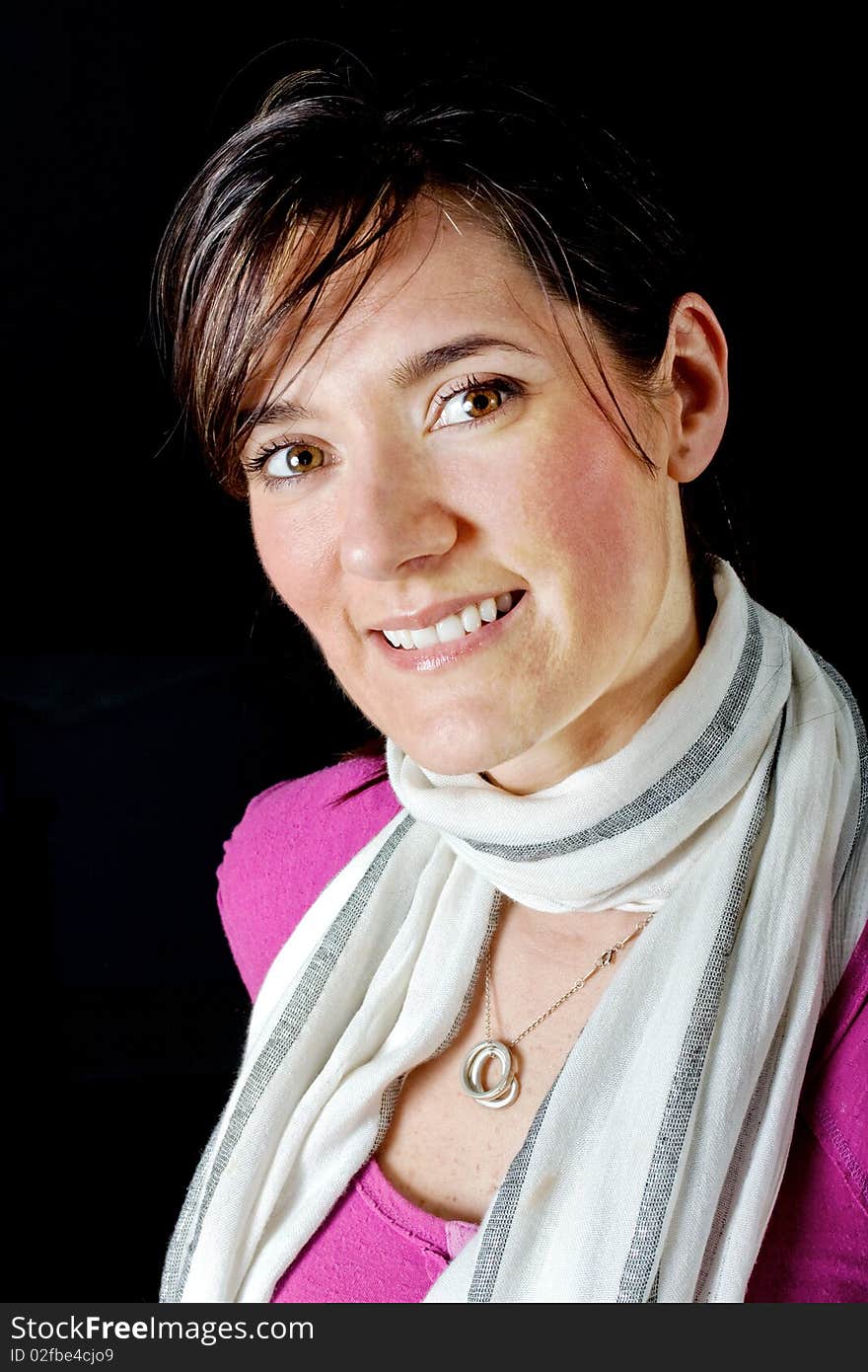 Portrait of a beautiful smiling fashionable stylish woman with a scarf on black background. Portrait of a beautiful smiling fashionable stylish woman with a scarf on black background