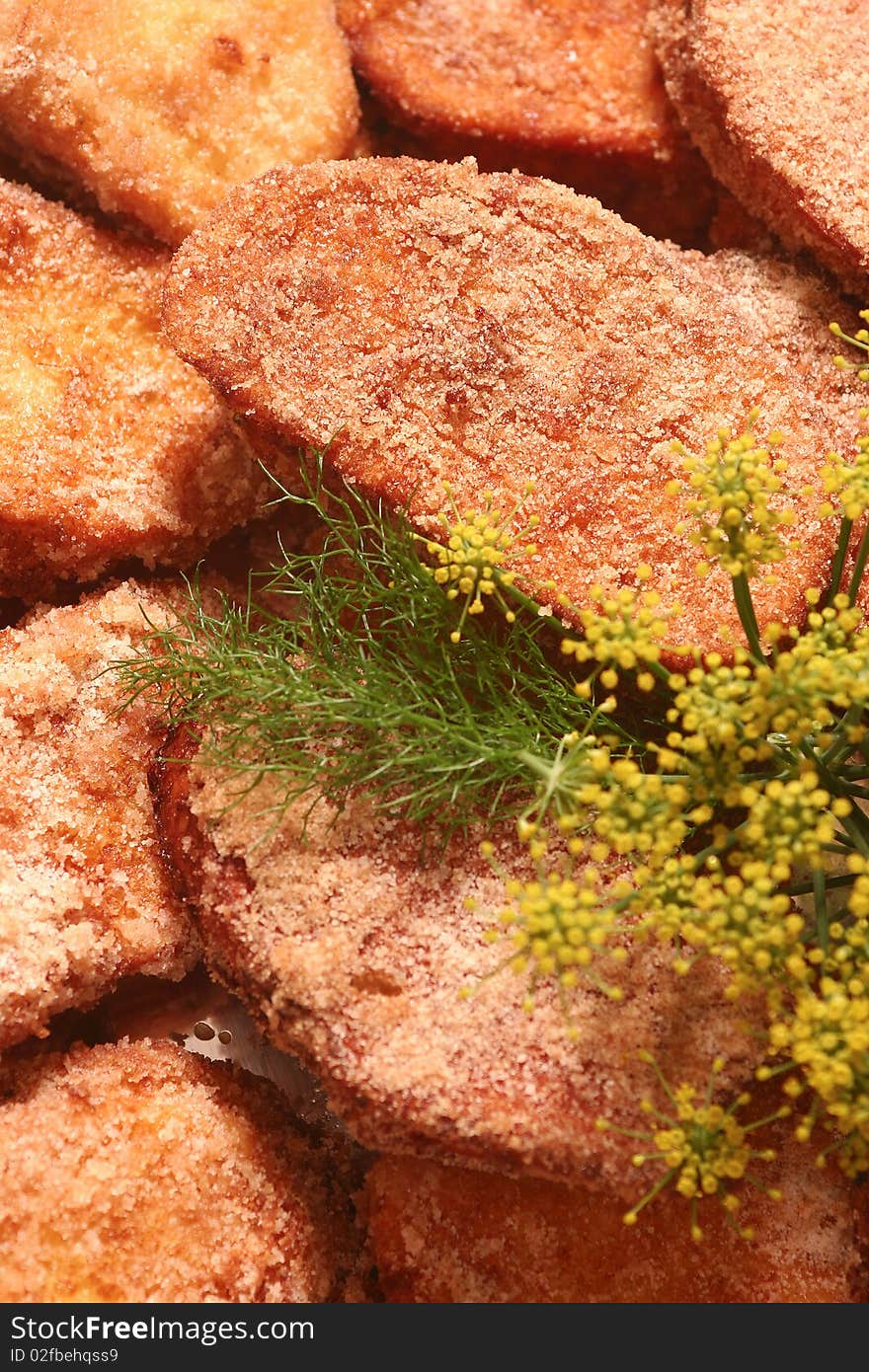 Many French toasts lined on a tray with fennel and camomile decoration for a Christmas dinner