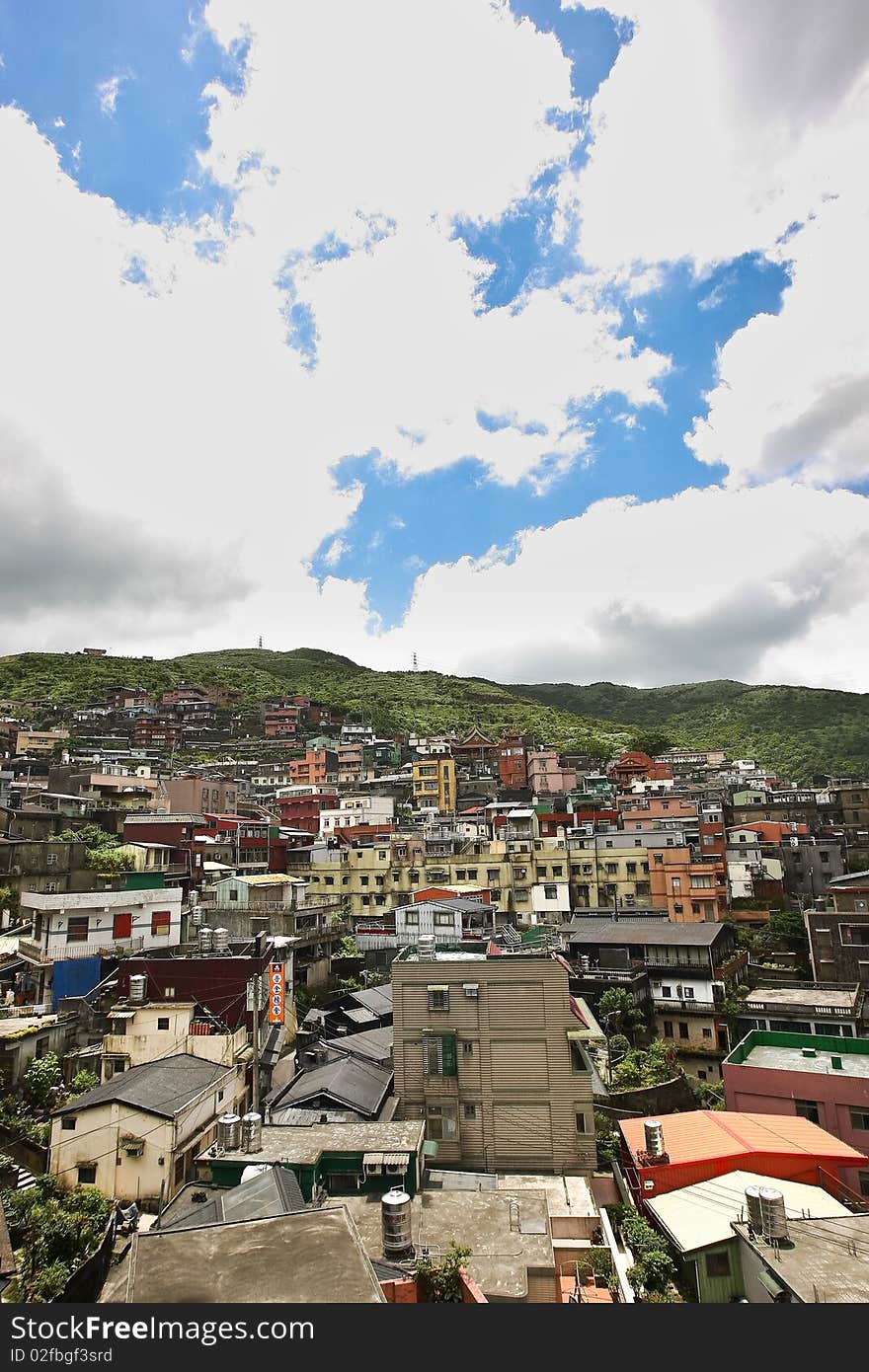 A beautiful bright sky with clouds over a dense suburban area in Taiwan. A beautiful bright sky with clouds over a dense suburban area in Taiwan.