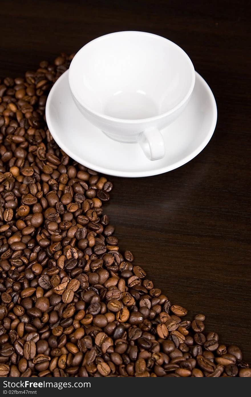 White coffee cup and coffee beans