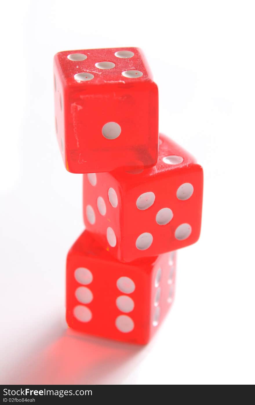 Three playing bones of red color on a white background.