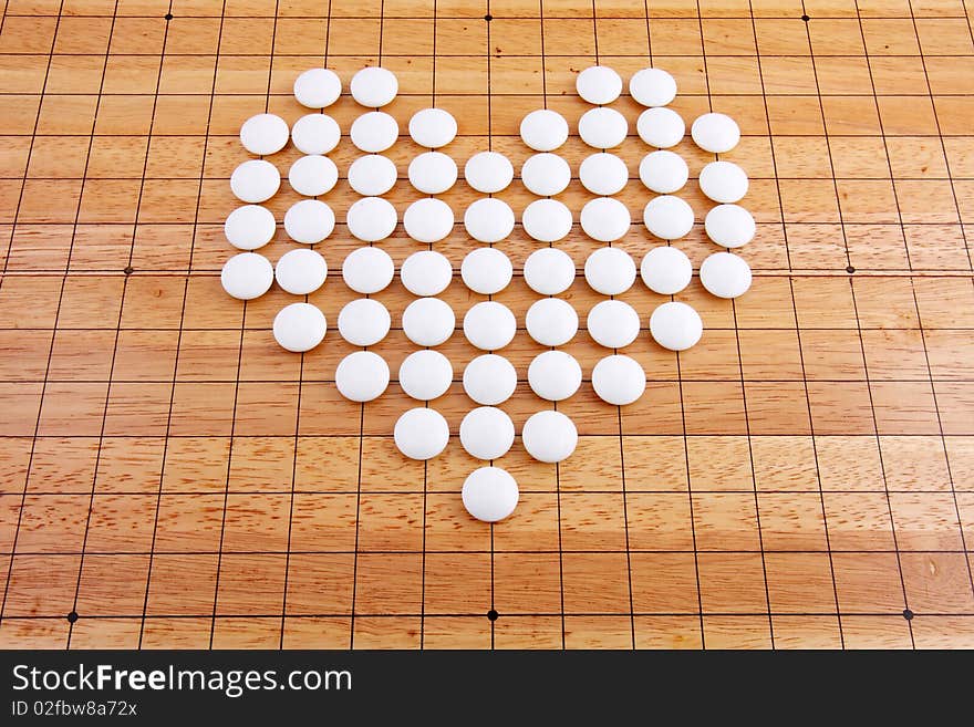 A white heart in a japanese Traditional go board. A white heart in a japanese Traditional go board