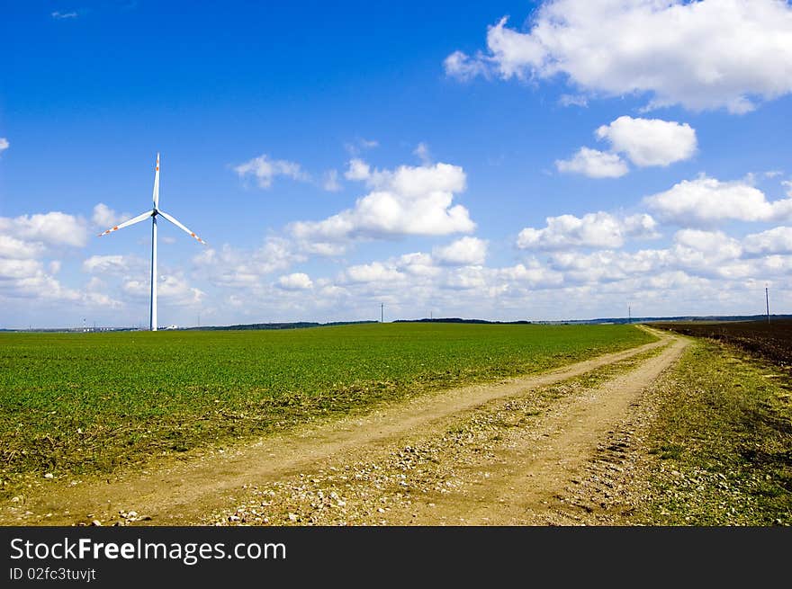 Windmill conceptual image. Windmill on the green field.