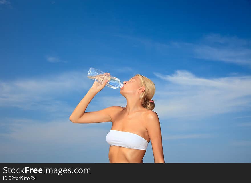 Woman Drinking Water On Beach.