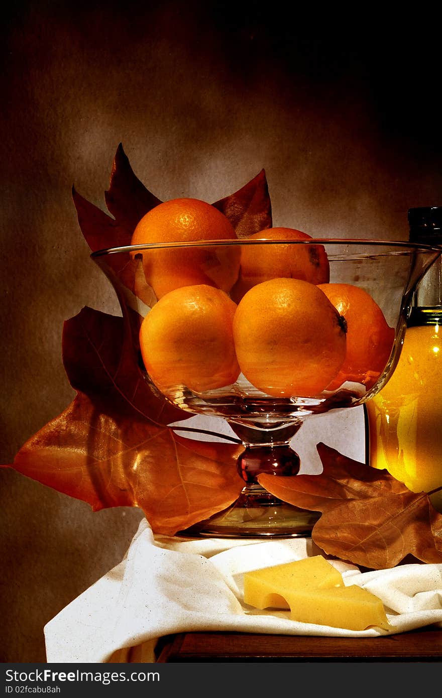 Autumnal still life of oranges and dry leaves. Autumnal still life of oranges and dry leaves