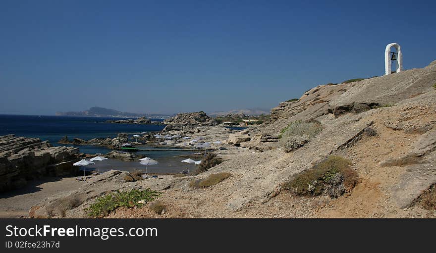 Kalithea beach with a bell tower in the island Rhodes in Greece