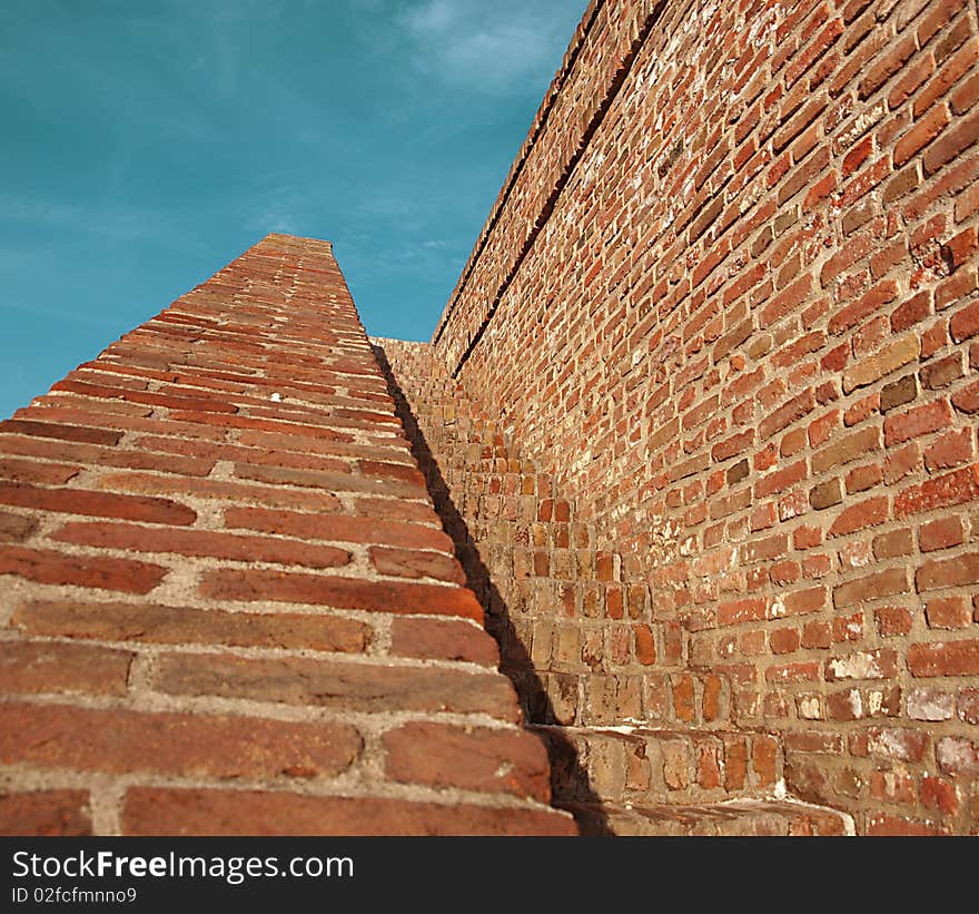 Grunge mysterious stairway made of red bricks