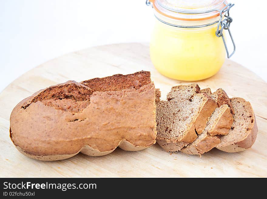 Brown sliced homemade bread with yellow cream