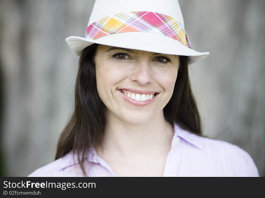 Portrait of a Smiling Young Woman Wearing a Hat. Portrait of a Smiling Young Woman Wearing a Hat