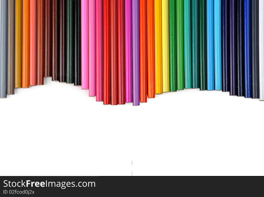 Colored pencils lined up in row