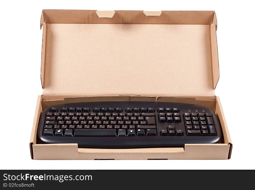 The keyboard in a cardboard box isolated on a white background. The keyboard in a cardboard box isolated on a white background.