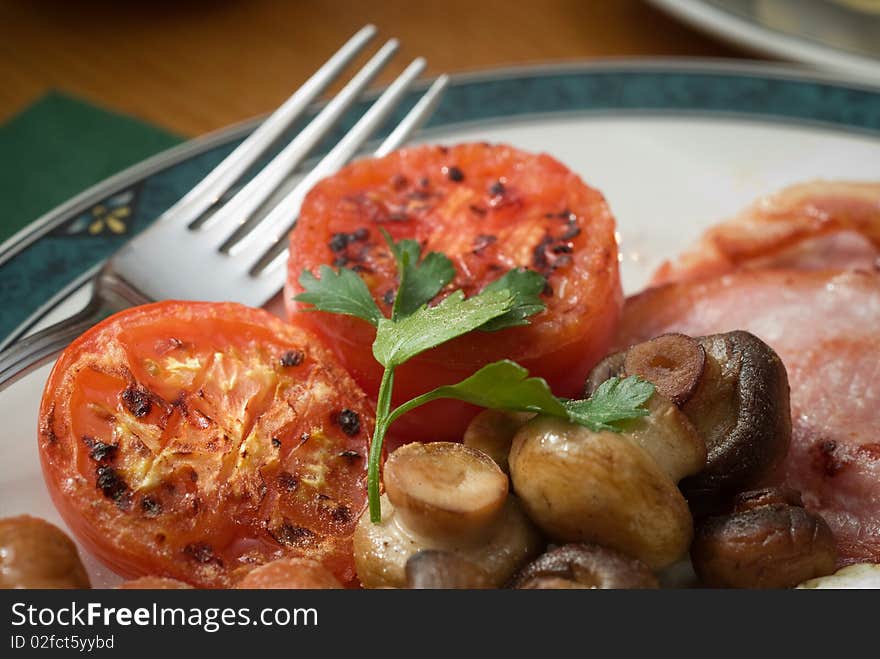 Grilled tomatoes as part of a traditional English Breakfast. Grilled tomatoes as part of a traditional English Breakfast.