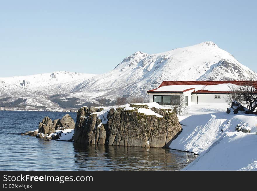 A lofoten's villa mirroring in Busknes fjord . A lofoten's villa mirroring in Busknes fjord