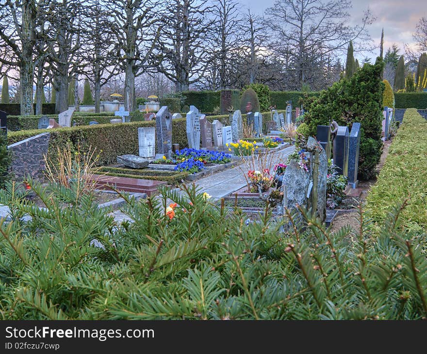 Colorful graveyard in Lausanne, Switzerland at dusk. An invitation to prayers, meditation and sacred thinking. Image in HDR. Colorful graveyard in Lausanne, Switzerland at dusk. An invitation to prayers, meditation and sacred thinking. Image in HDR.