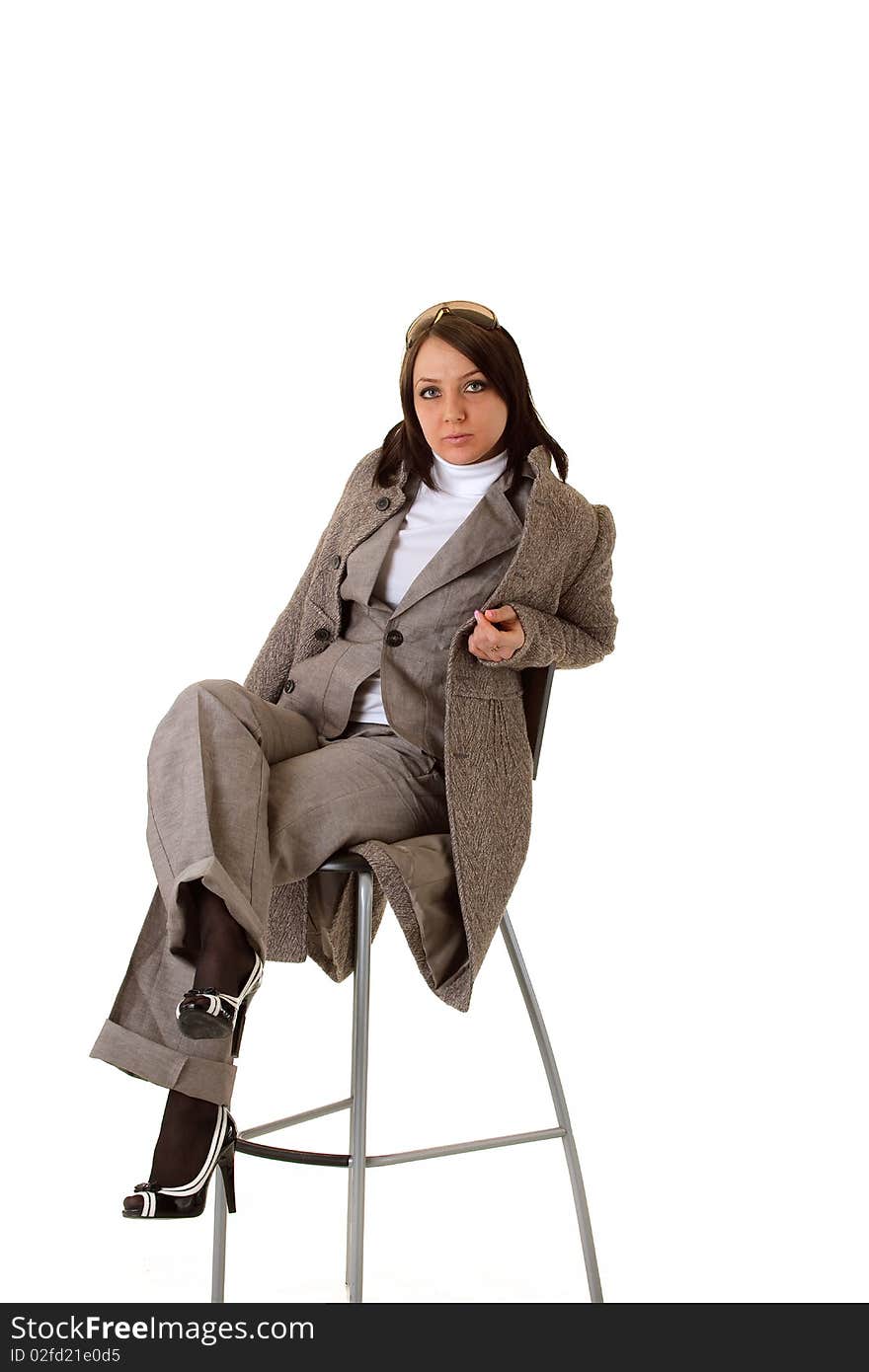 Sexy elegant business woman is posing on a chair