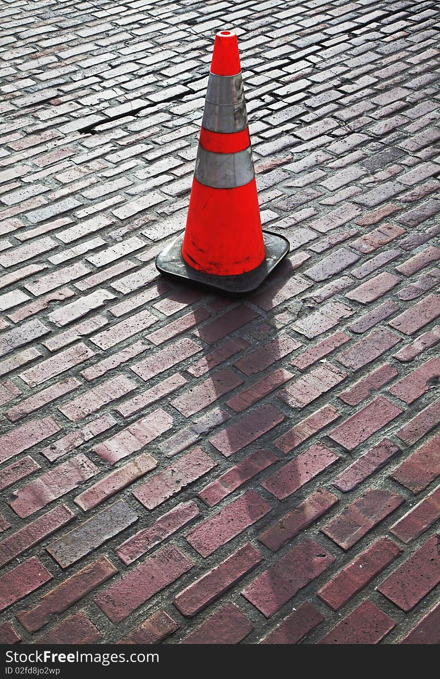 Traffic cone on brick street