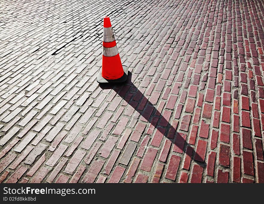 Traffic cone on brick street