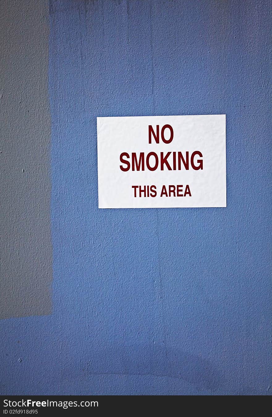 No smoking sign mounted near business area