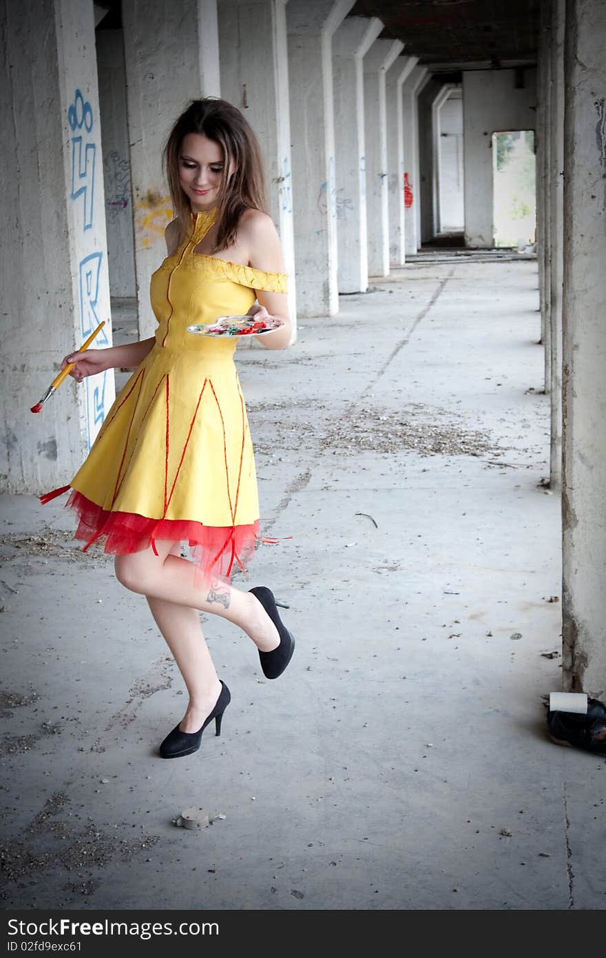 Women in yellow dress painting