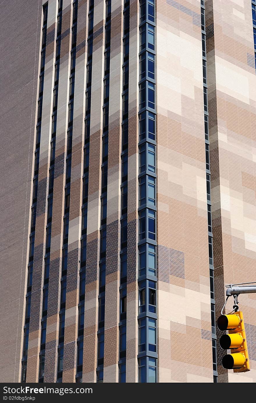 A patchy brown brick Building with a stop light. A patchy brown brick Building with a stop light.