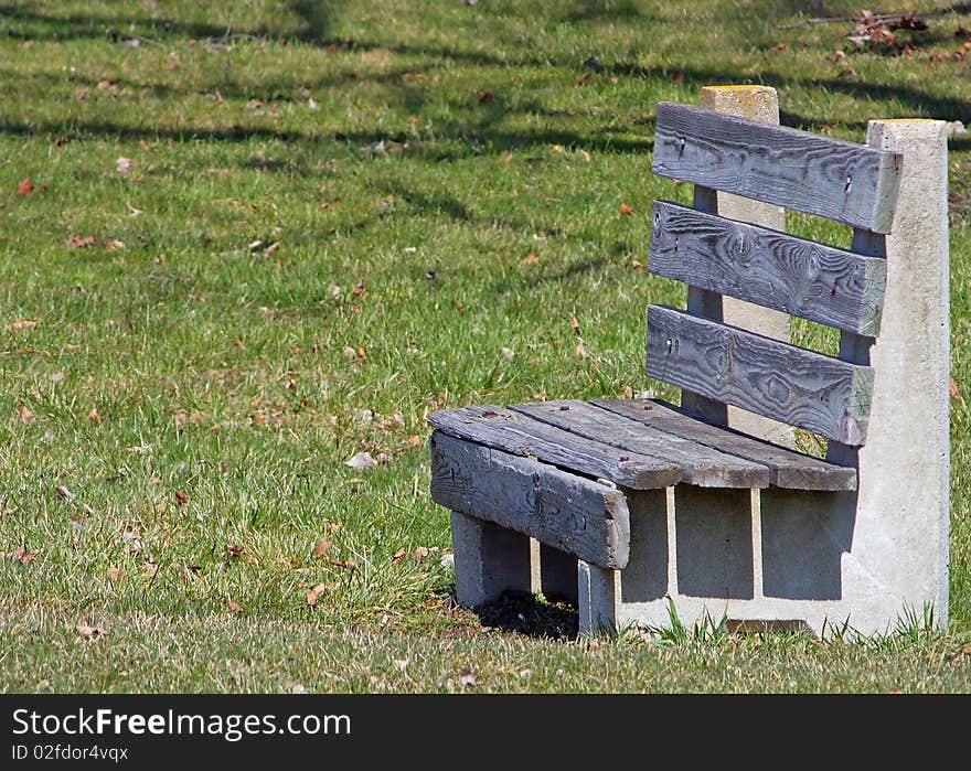 A wood park bench in Centennial Park in Fowlerville Michigan. A wood park bench in Centennial Park in Fowlerville Michigan.