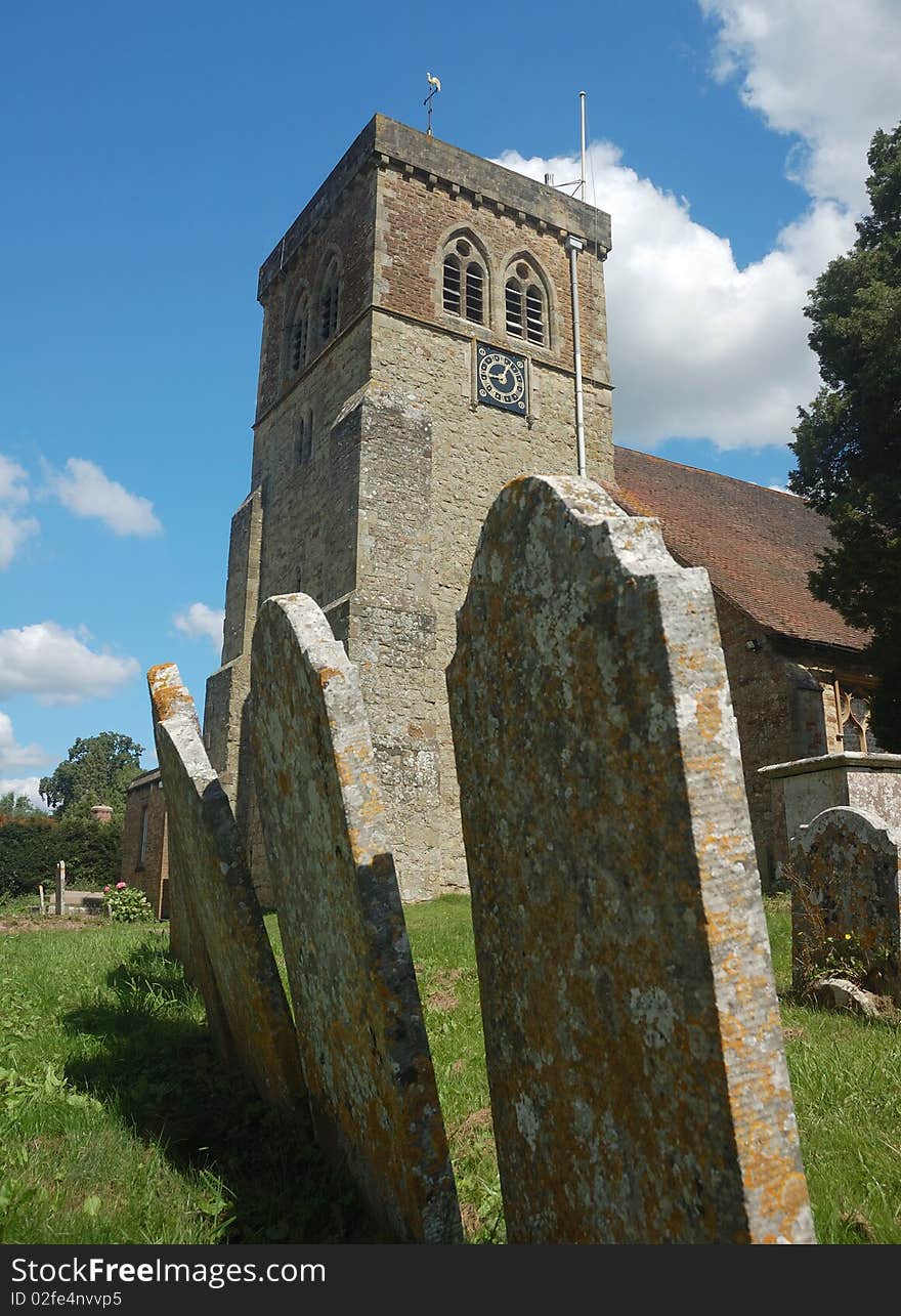 English parish church behind old gravestones. English parish church behind old gravestones