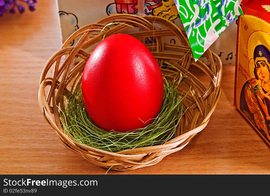 Red Easter egg in a basket. Red Easter egg in a basket.