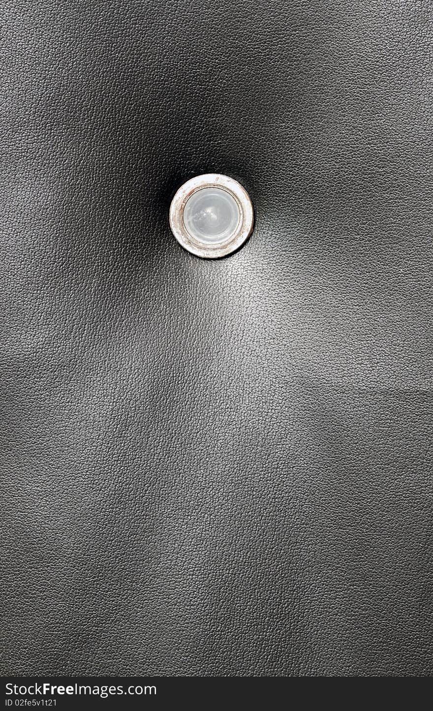 Dark grungy door leather with peeling door spy hole